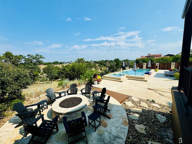 view of patio with a fire pit and a pool with hot tub