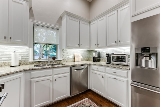 kitchen with dark hardwood / wood-style flooring, sink, white cabinets, and appliances with stainless steel finishes