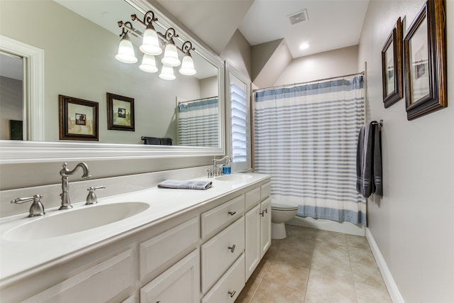 bathroom with tile patterned flooring, vanity, and toilet