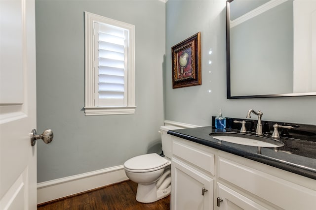 bathroom featuring vanity, hardwood / wood-style flooring, toilet, and baseboard heating