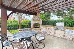 view of patio featuring an outdoor kitchen, ceiling fan, and a pergola