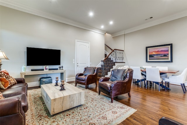 living room featuring hardwood / wood-style floors and ornamental molding