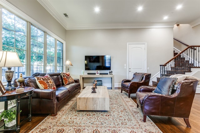 living room with crown molding and hardwood / wood-style flooring