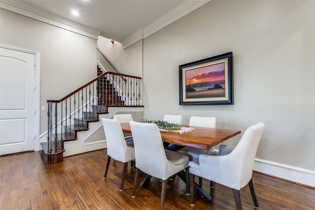 dining area featuring dark hardwood / wood-style floors and crown molding