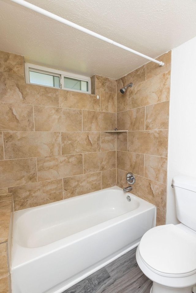 2404 Windsor Pl, Plano, TX 75075 - bathroom featuring toilet, bathtub / shower combination, and a textured ceiling