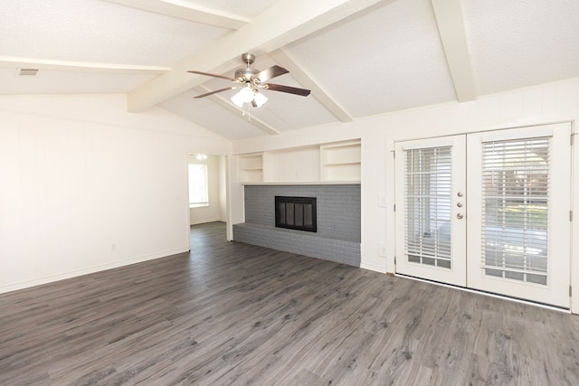 unfurnished living room featuring vaulted ceiling with beams, plenty of natural light, dark wood-type flooring, and french doors