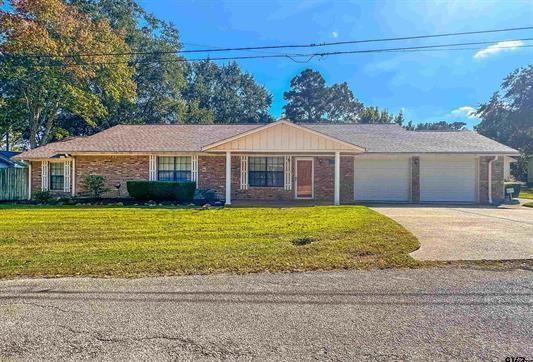 ranch-style house with a front lawn and a garage