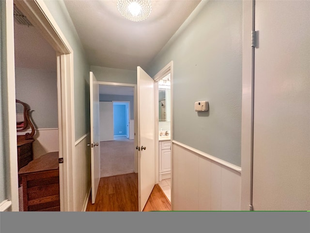 corridor with light hardwood / wood-style floors