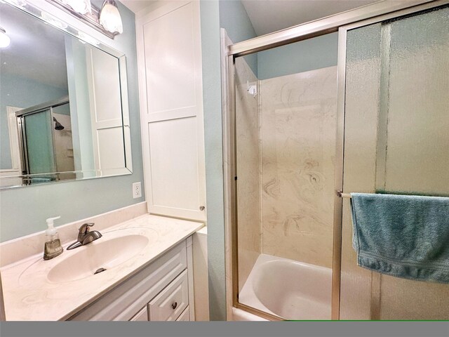 bathroom with vanity and bath / shower combo with glass door