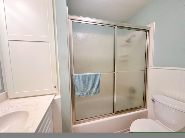 full bathroom with vanity, toilet, and combined bath / shower with glass door