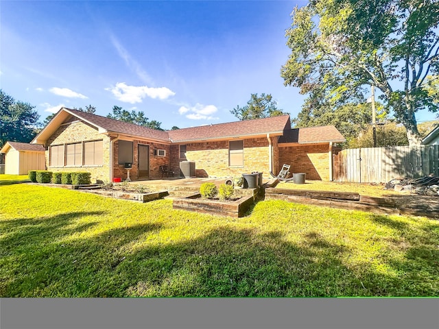 back of house with a patio and a lawn