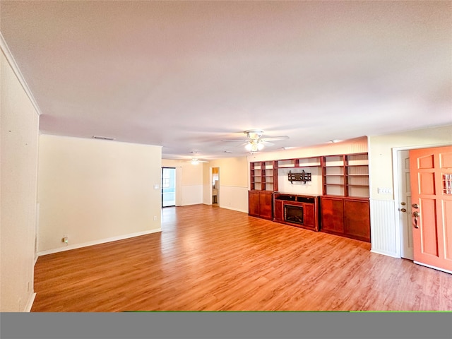 unfurnished living room featuring light hardwood / wood-style flooring and ceiling fan