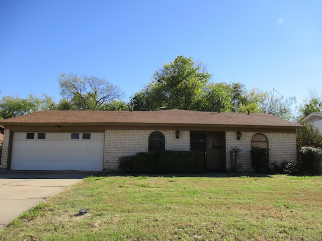 ranch-style home featuring a front yard and a garage