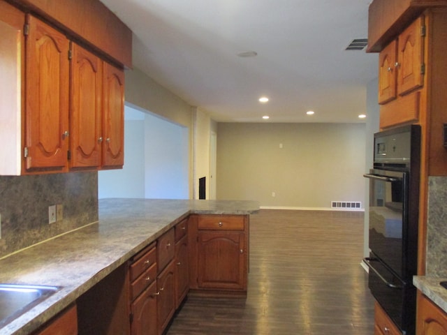 kitchen with backsplash, kitchen peninsula, dark wood-type flooring, and black double oven