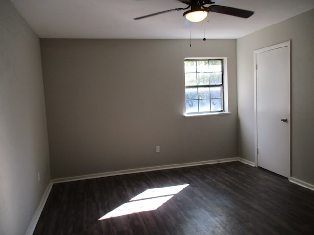 empty room with dark hardwood / wood-style floors and ceiling fan