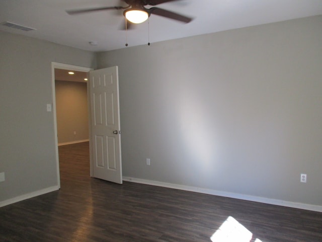 unfurnished room with ceiling fan and dark hardwood / wood-style flooring