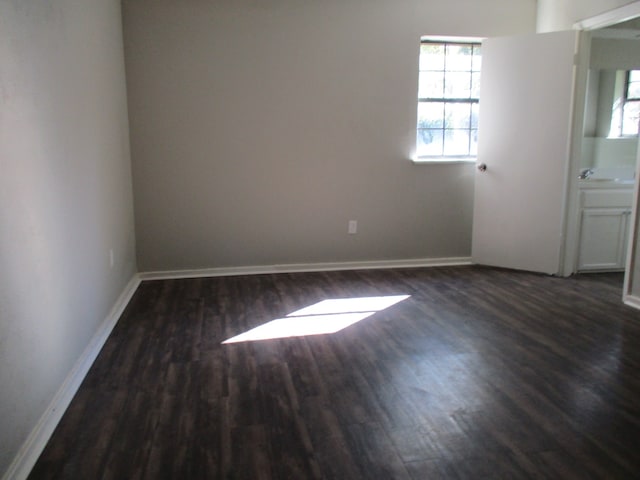 empty room with dark hardwood / wood-style floors