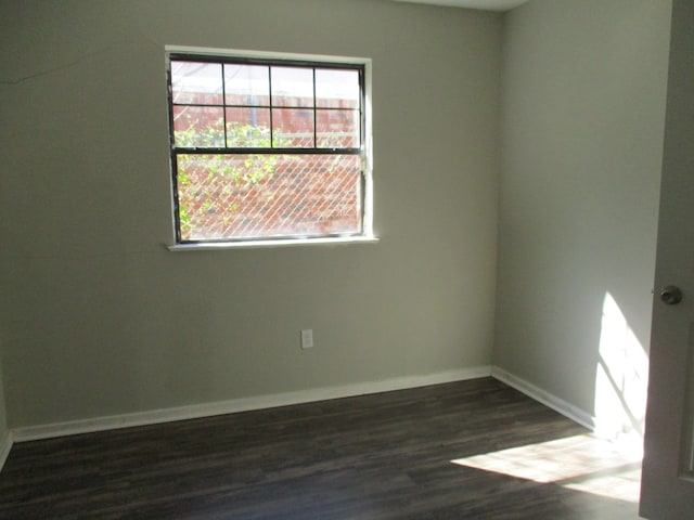 spare room featuring dark wood-type flooring