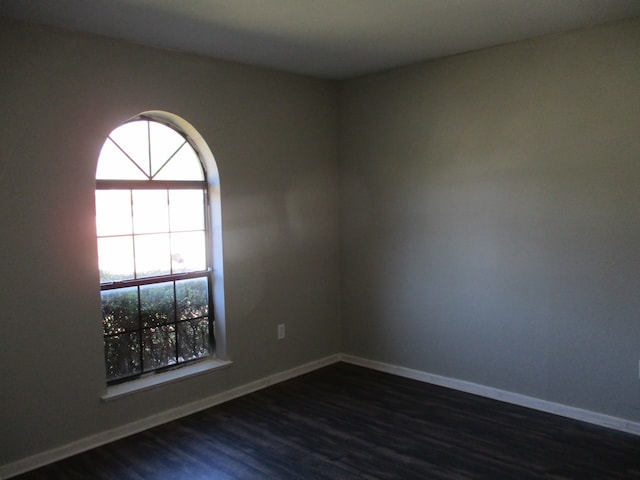 spare room with dark hardwood / wood-style flooring