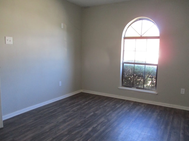 spare room featuring dark wood-type flooring