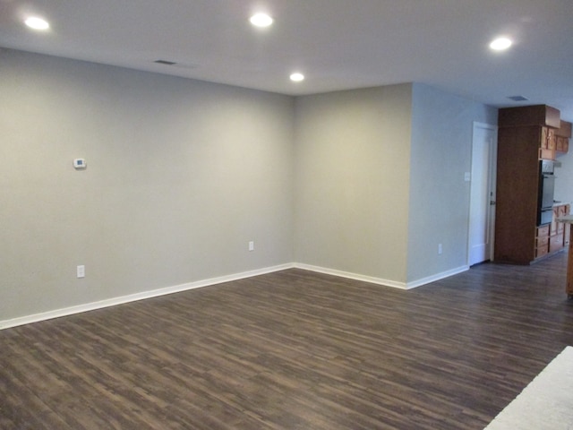 spare room featuring dark hardwood / wood-style floors