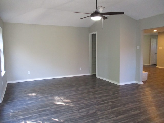 spare room featuring ceiling fan, dark hardwood / wood-style flooring, and lofted ceiling