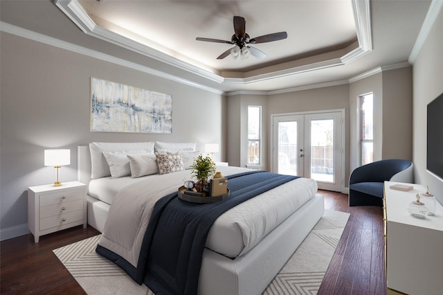 bedroom with access to outside, french doors, dark wood-style floors, a raised ceiling, and crown molding