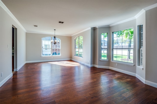 spare room with a notable chandelier, ornamental molding, and dark wood-type flooring