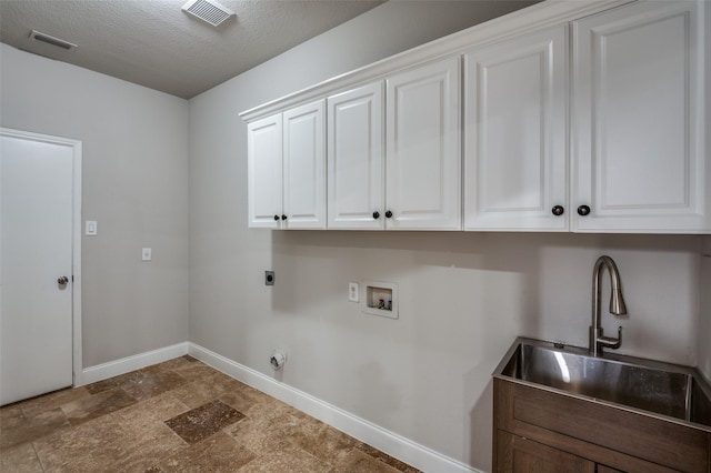 laundry area featuring hookup for a washing machine, cabinet space, visible vents, and electric dryer hookup