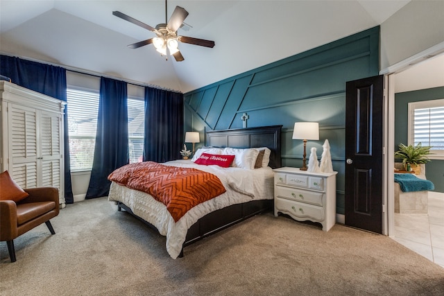 bedroom featuring light carpet, vaulted ceiling, and ceiling fan