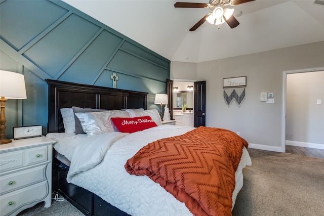 bedroom featuring ceiling fan, lofted ceiling, carpet floors, and ensuite bath