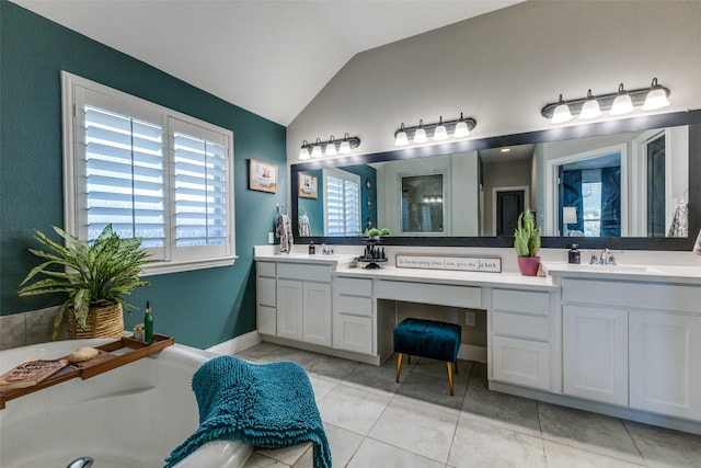 bathroom with tile patterned flooring, vanity, and vaulted ceiling