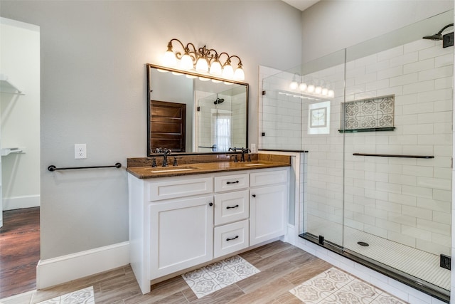 bathroom with vanity, an enclosed shower, and hardwood / wood-style flooring