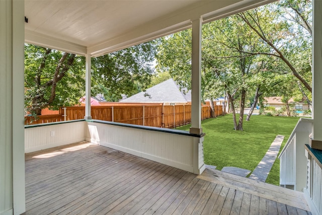 wooden terrace featuring a yard