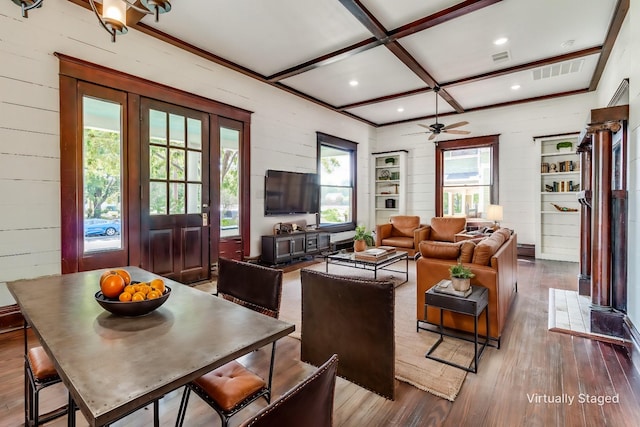 living room featuring wood walls, coffered ceiling, and hardwood / wood-style flooring