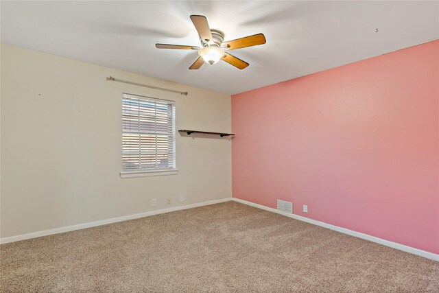 carpeted empty room featuring ceiling fan