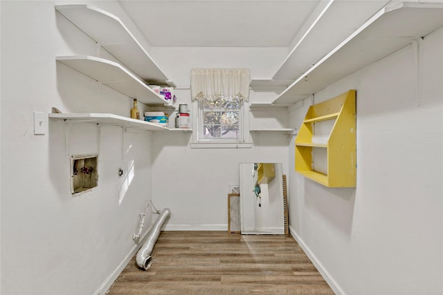 2680 Hubbard St, Paris, TX 75460 - laundry area featuring electric dryer hookup, hookup for a washing machine, wood finished floors, and baseboards