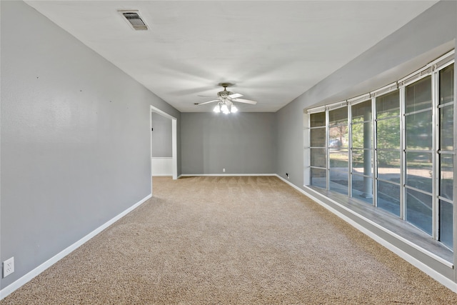 carpeted empty room featuring ceiling fan