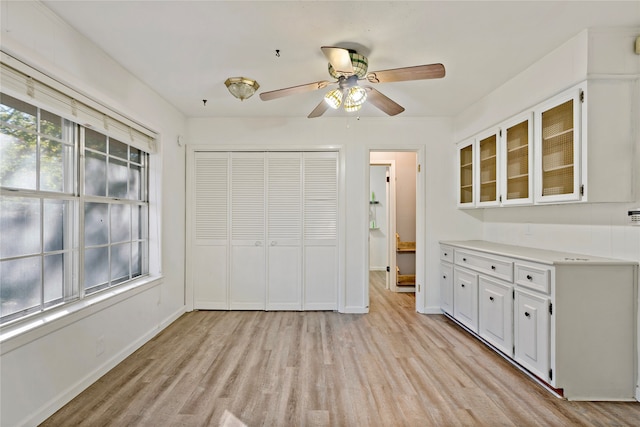 interior space with ceiling fan and light wood-type flooring