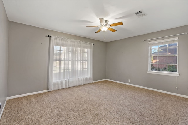 carpeted spare room with ceiling fan