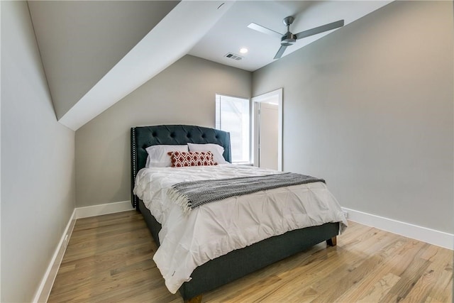 bedroom with hardwood / wood-style floors, ceiling fan, and vaulted ceiling