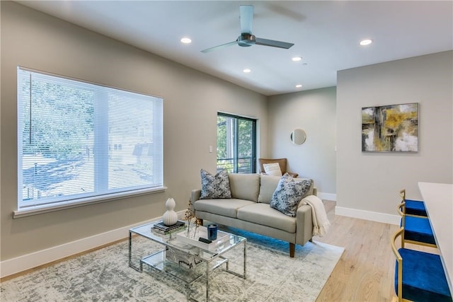 living room with ceiling fan and light wood-type flooring