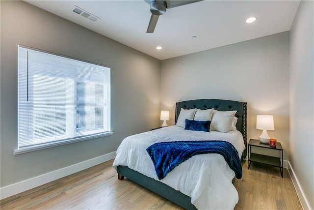 bedroom with ceiling fan and hardwood / wood-style floors