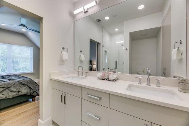 bathroom featuring hardwood / wood-style floors, vanity, vaulted ceiling, and ceiling fan