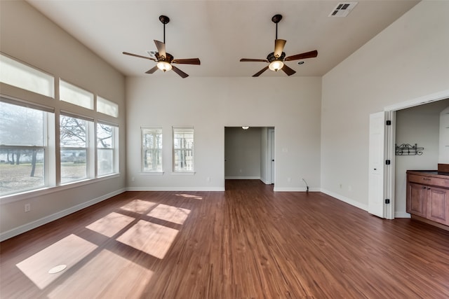 unfurnished living room with ceiling fan and dark hardwood / wood-style flooring