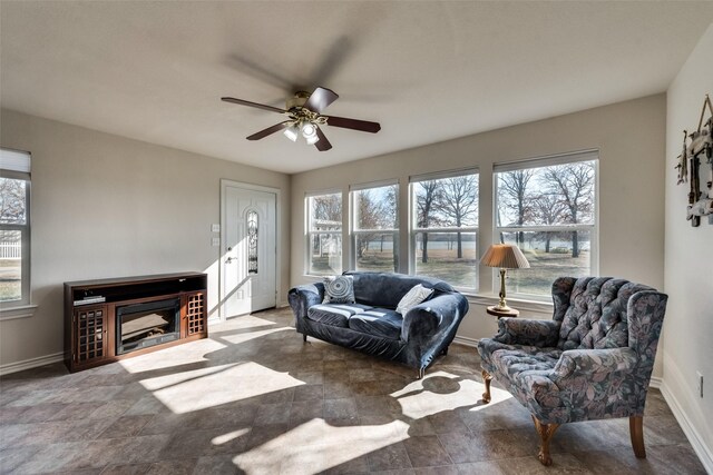 living room featuring ceiling fan and a healthy amount of sunlight