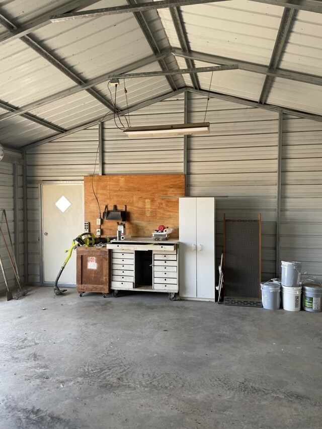 garage with a workshop area and wood walls