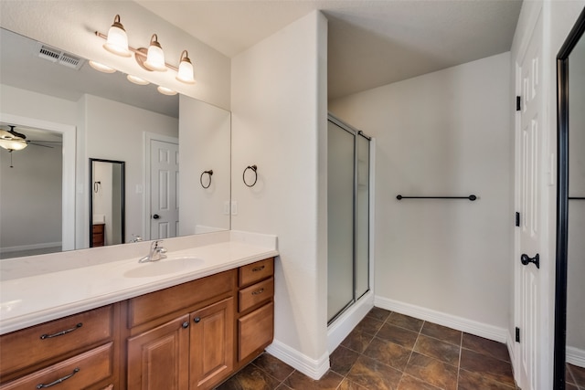 bathroom with vanity, ceiling fan, and a shower with door