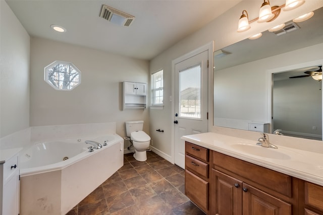 bathroom featuring vanity, ceiling fan, toilet, and a tub to relax in