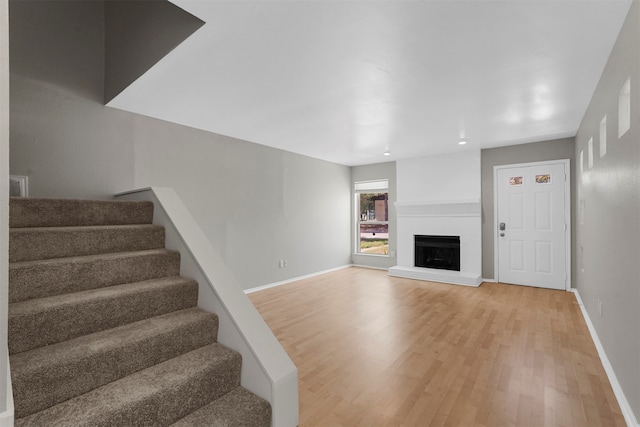 unfurnished living room with wood-type flooring